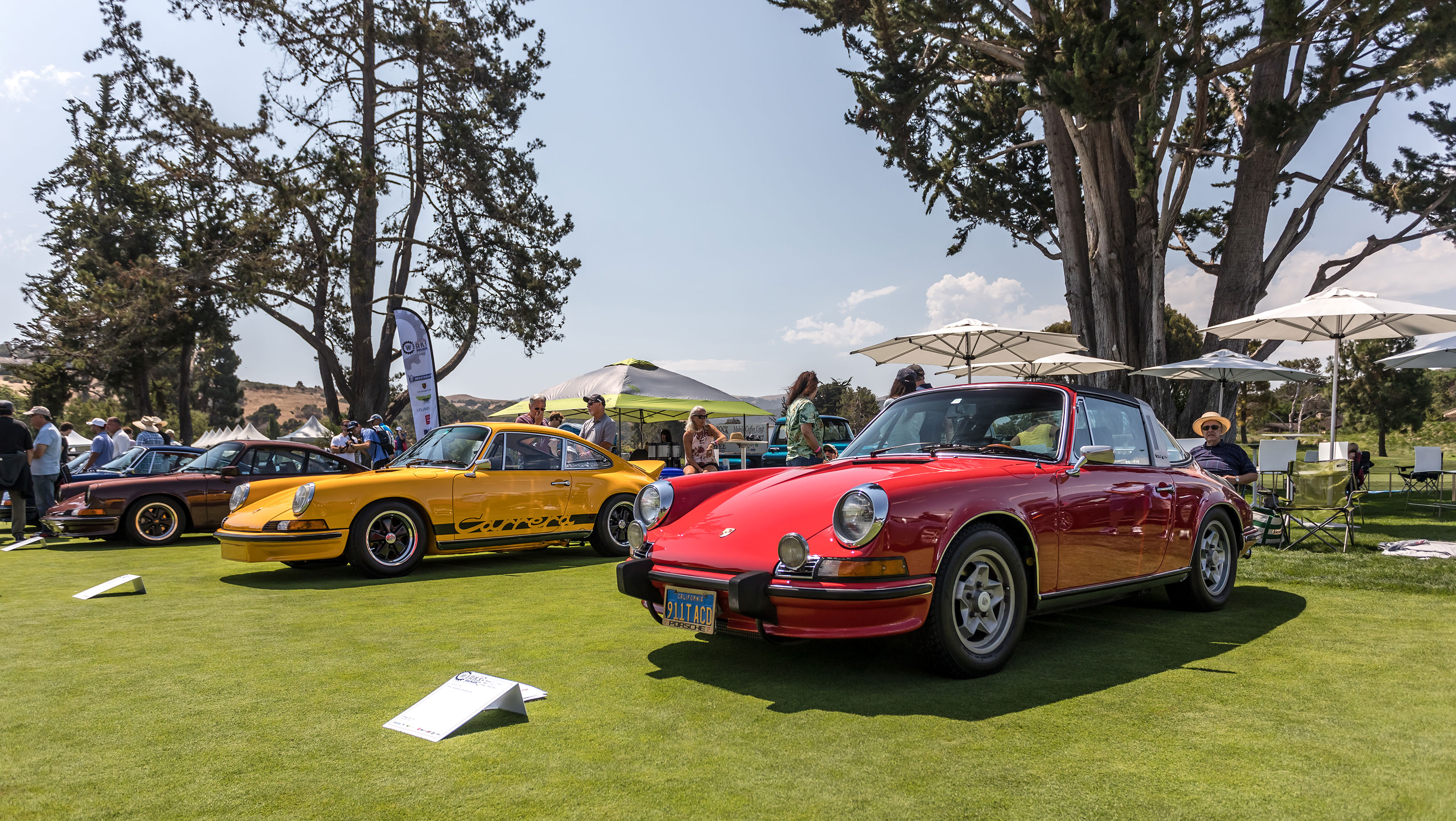 Yellow and red Porsche 911 cars at Monterey show