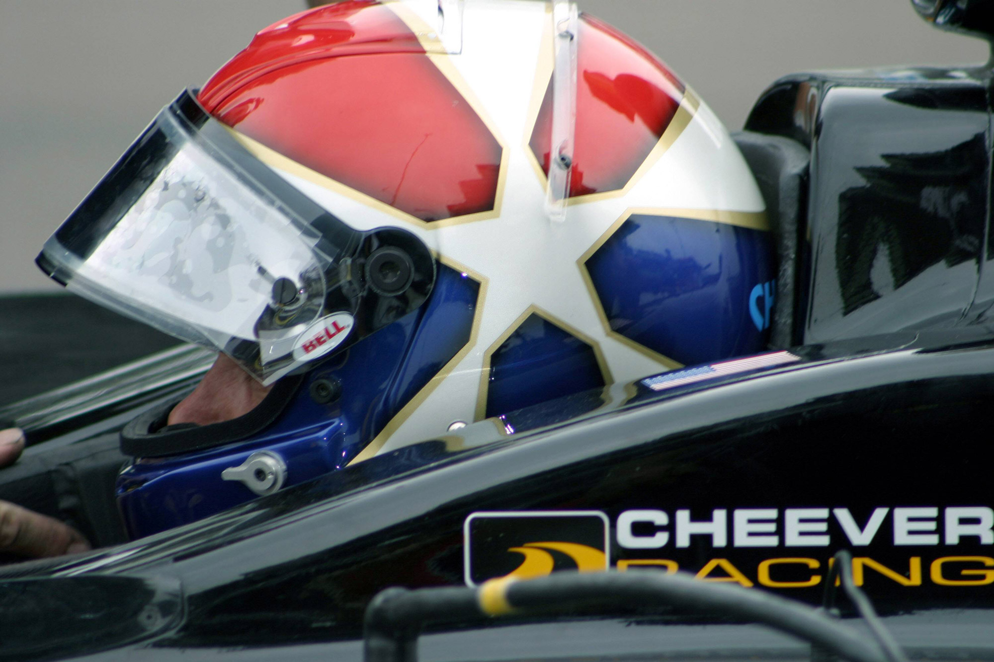 Driver wearing race helmet combining US flag with Arizona flag