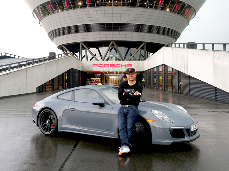 Man outside Porsche Delivery Centre with grey 911 Carrera GTS
