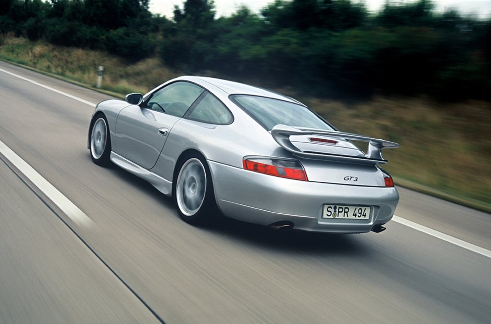 Silver Porsche 911 GT3 (type 996) driving on the road