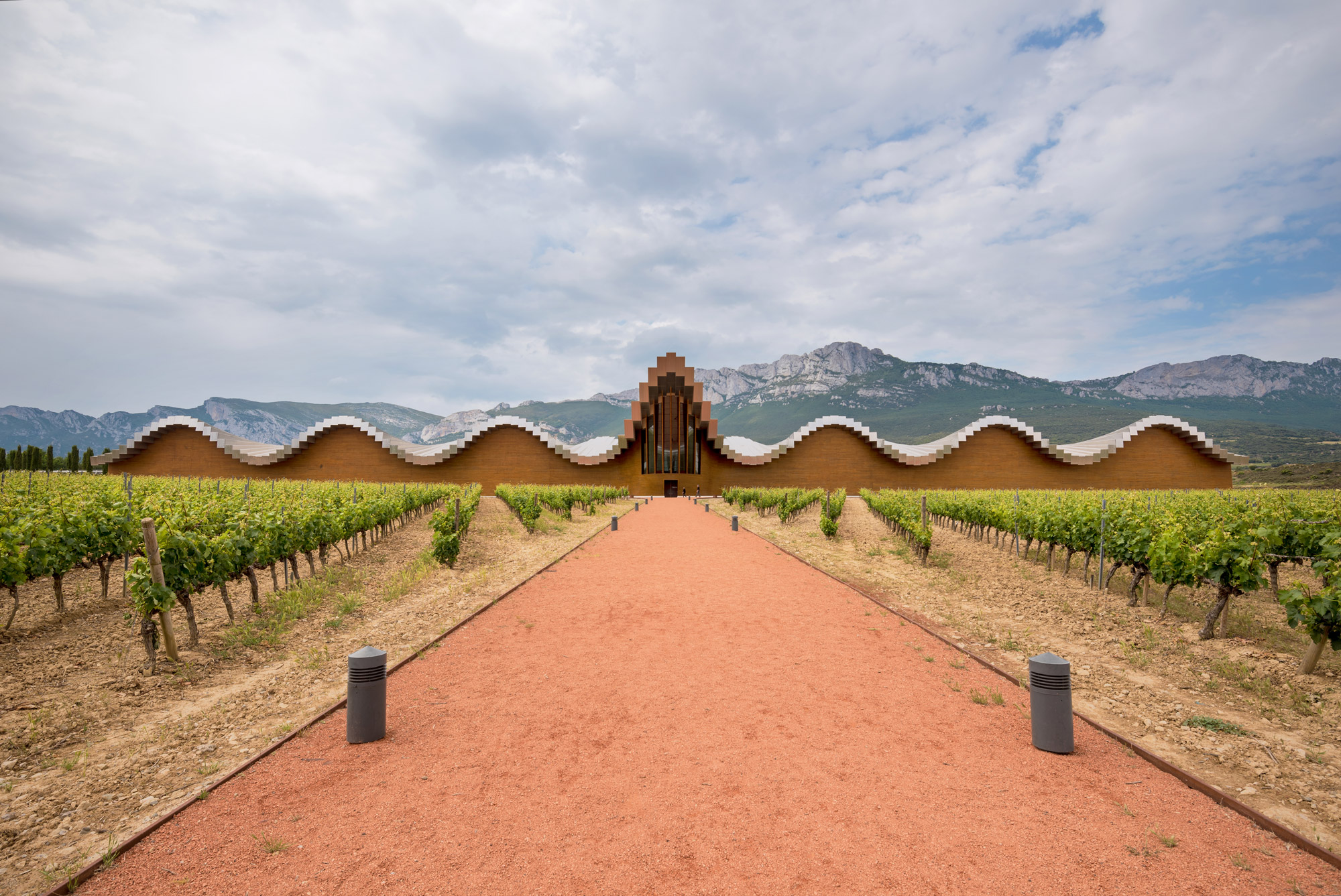 Undulating architecture set against a mountain backdrop