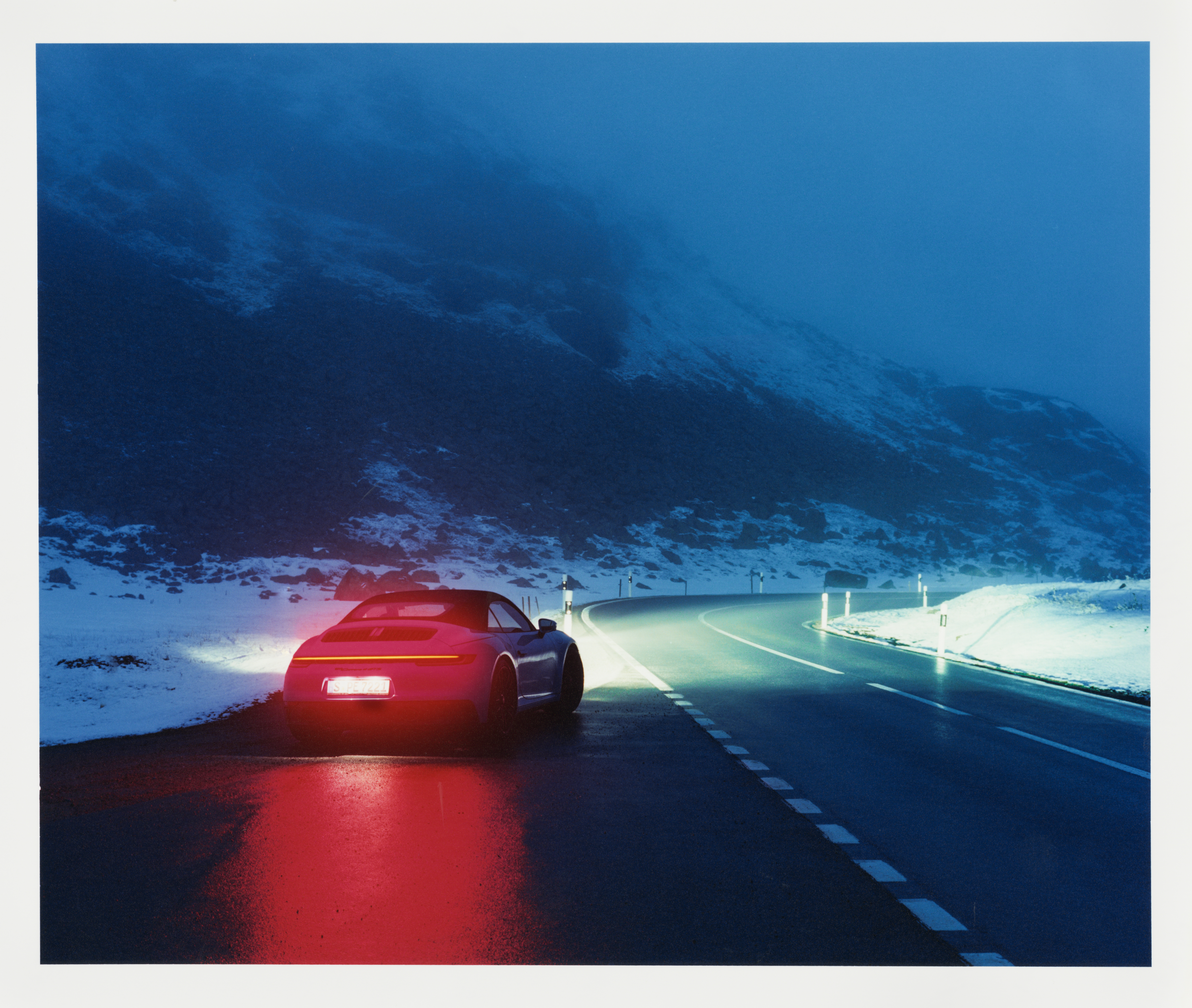 Porsche 911 Carrera 4 GTS Cabriolet on dark, icy road