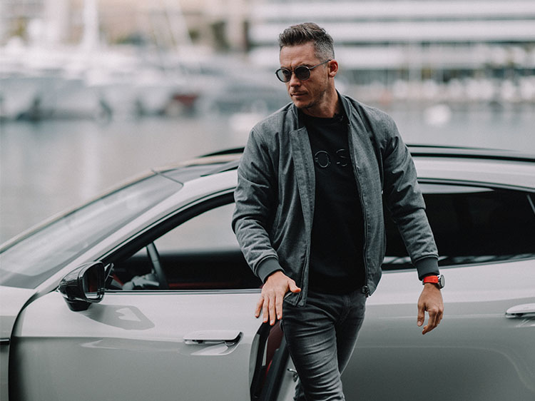 Racing driver André Lotterer behind the wheel of a Porsche Taycan Cross Turismo