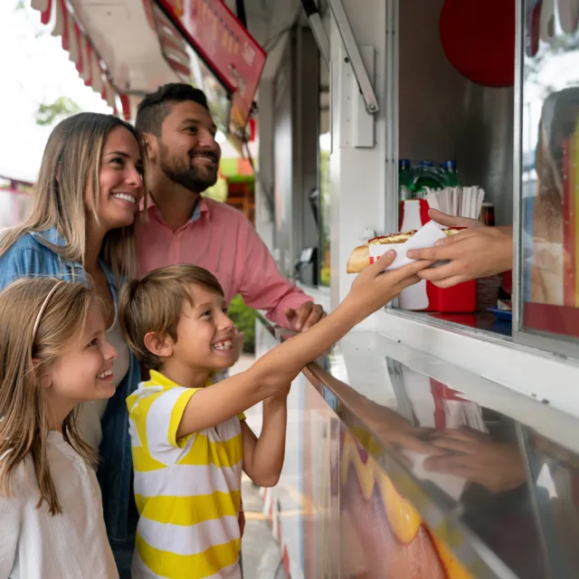 A family buying fast food from a food truck