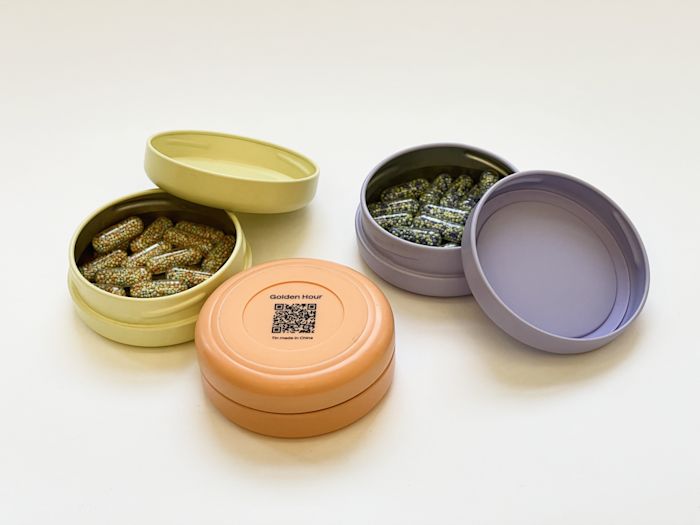 Two First Person tins with a Batch QR Code.