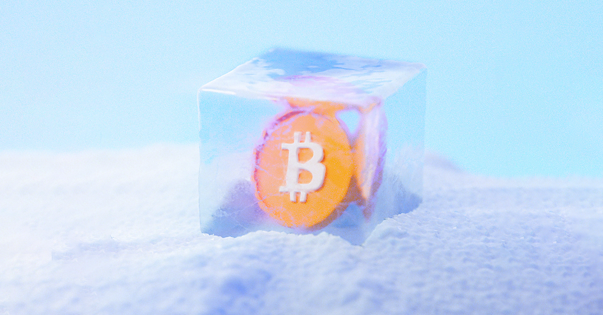 Bitcoin symbol in ice on top of a snow pile