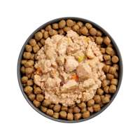Bowl of kibble topped with Go! Booster Carnivore Minced Chicken Salmon + Duck recipe for cats