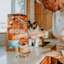 Cat watching owner pour NOW FRESH kibble into bowl on kitchen counter