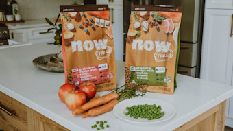 Now Fresh dog food kibble bags on counter with peas and carrots