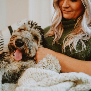 Image of a woman snuggling with her dog