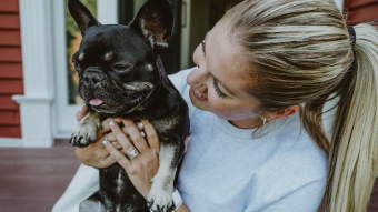 Woman holding French Bulldog