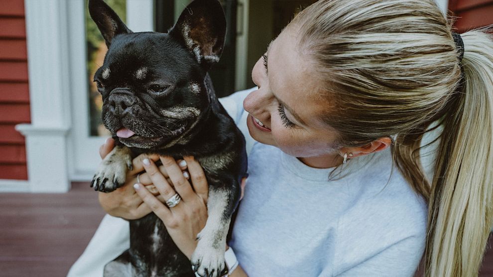 Woman holding French Bulldog