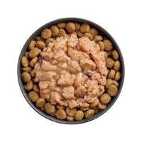 Bowl of kibble topped with Go! Booster Immune Health Minced Chicken recipe for dogs