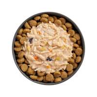 Bowl of kibble topped with Go! Booster Immune Health Shredded Chicken + Salmon recipe for dogs
