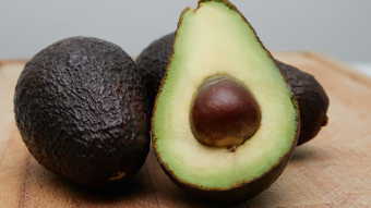 Three avocados on cutting board