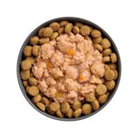 Bowl of kibble topped with Go! Booster Tranquility Minced Chicken recipe for dogs