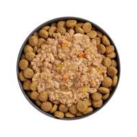 Bowl of kibble topped with Go! Booster Digestive Health Chicken + Lamb recipe for dogs