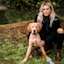 Woman with ripped jeans and Golden Retriever puppy
