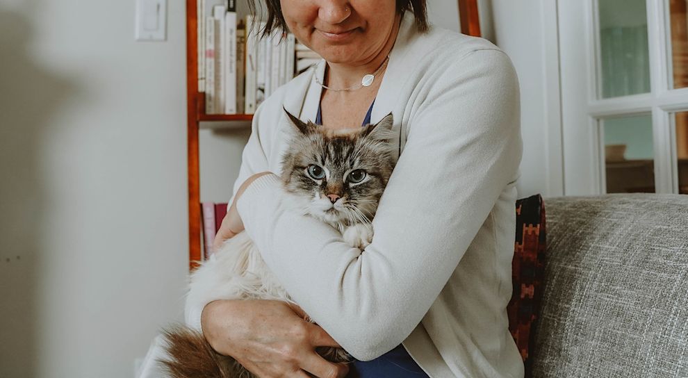 Woman holding blue-eyed cat