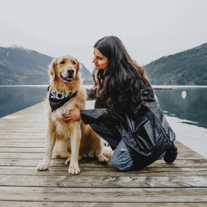 Woman petting Golden Retriever on dock