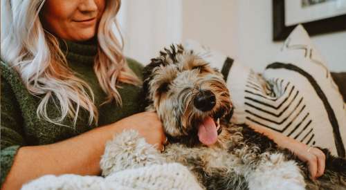 Woman snuggling with her dog