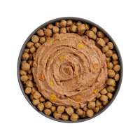 Bowl of kibble topped with Go! Booster Digestive Health Tuna + Salmon Pâté for cats