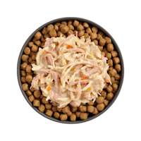 Bowl of kibble topped with Go! Booster Weight Management Shredded Chicken + Duck recipe for cats