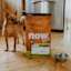 Dog standing beside bag of Now Fresh small breed adult dog food