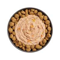 Bowl of kibble topped with Go! Booster Digestive Health Chicken + Duck Pâté for dogs