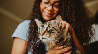 Young girl and tabby cat snuggling