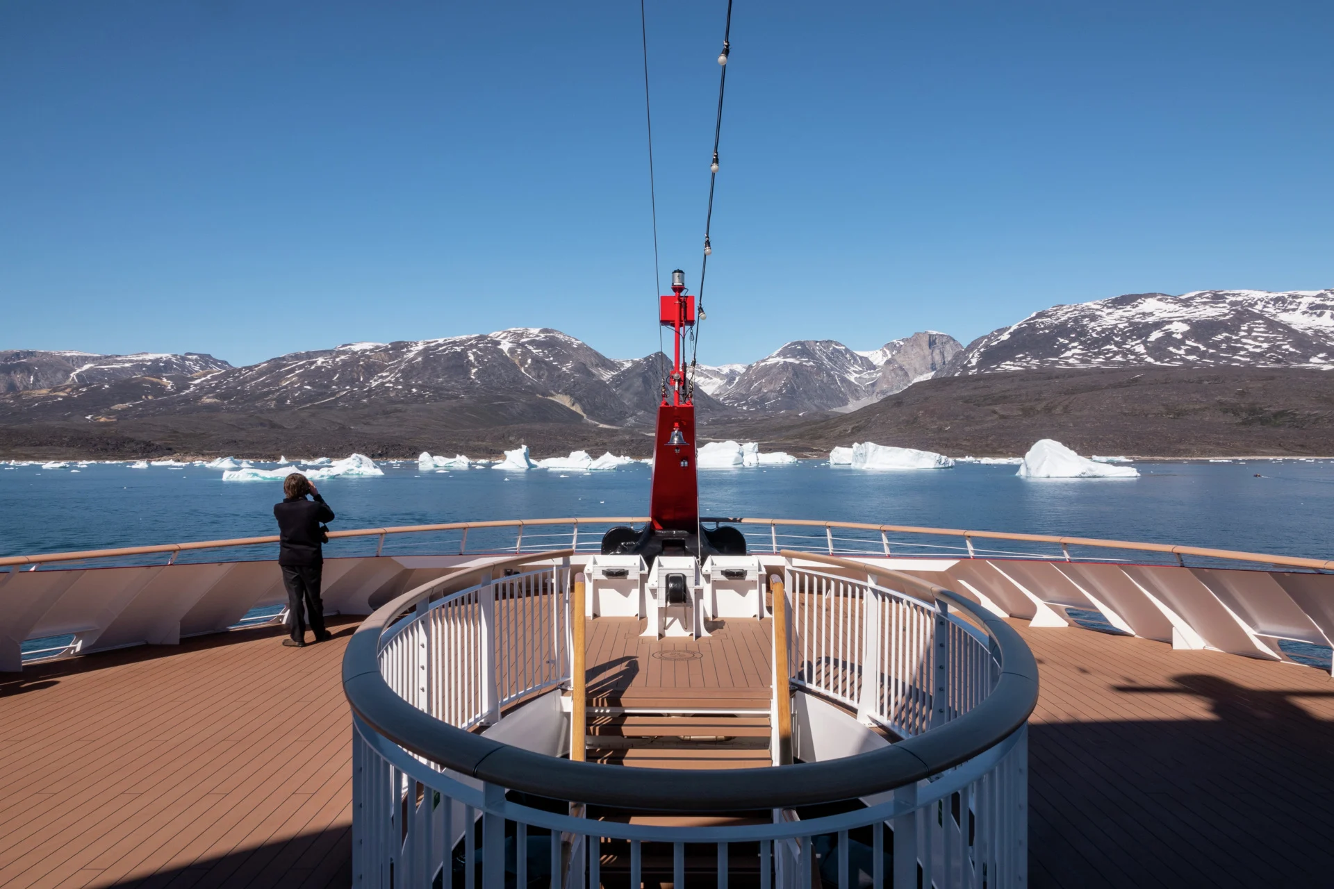 A guest photographing from the observation deck on board MS Fridtjof Nansen, Camp Frieda, Greenland. Credit: Andrea Klaussner.