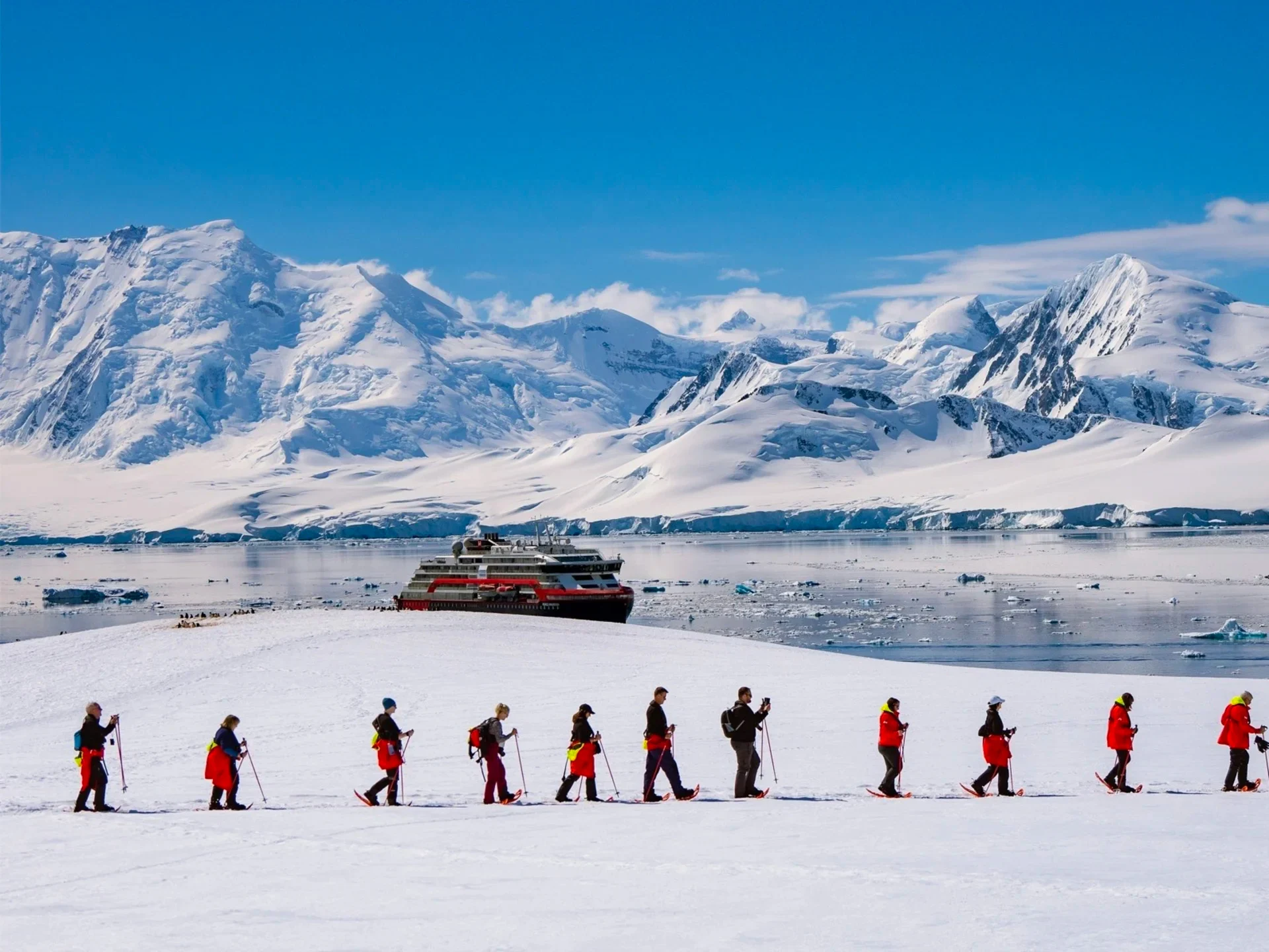 Guests on a hike in front of MS Roald Amundsen across Damoy Point in Antarctica. Credit: Espen Mills