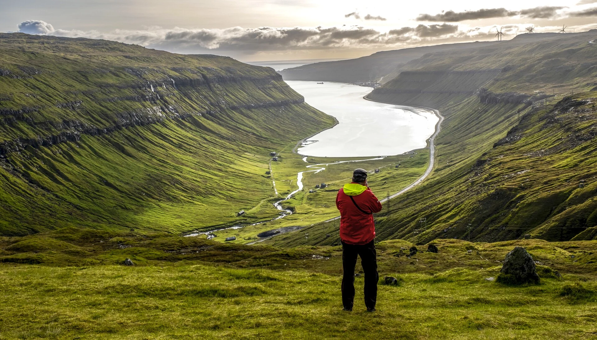 Guests taking a photo on a hike on the outskirts of Torshavn, Faroe Islands. Credit: Tommy Simonsen / HX Hurtigruten Expeditions