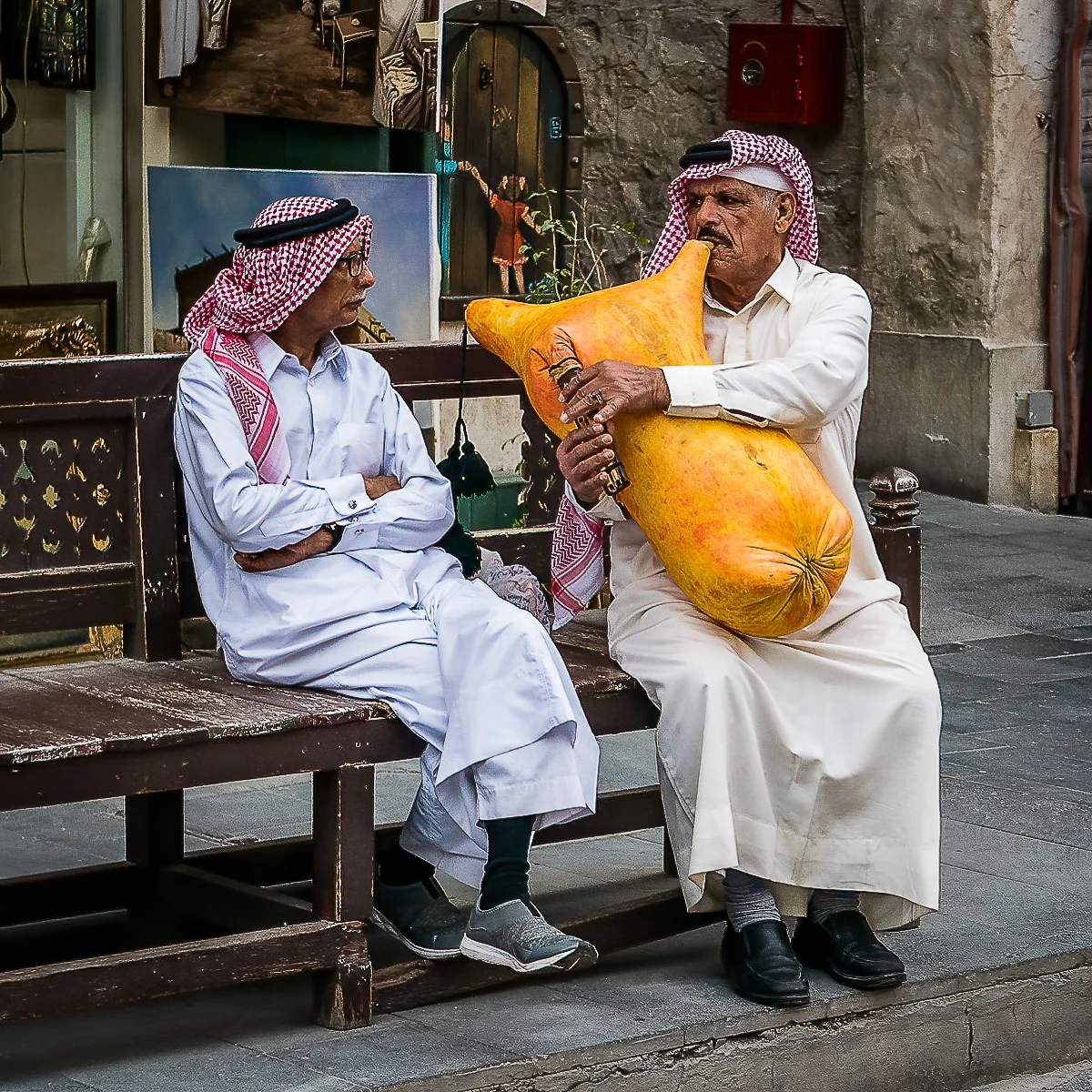A man plays the bagpipes for an unimpressed onlooker in Doha. Taken by David Uffindall