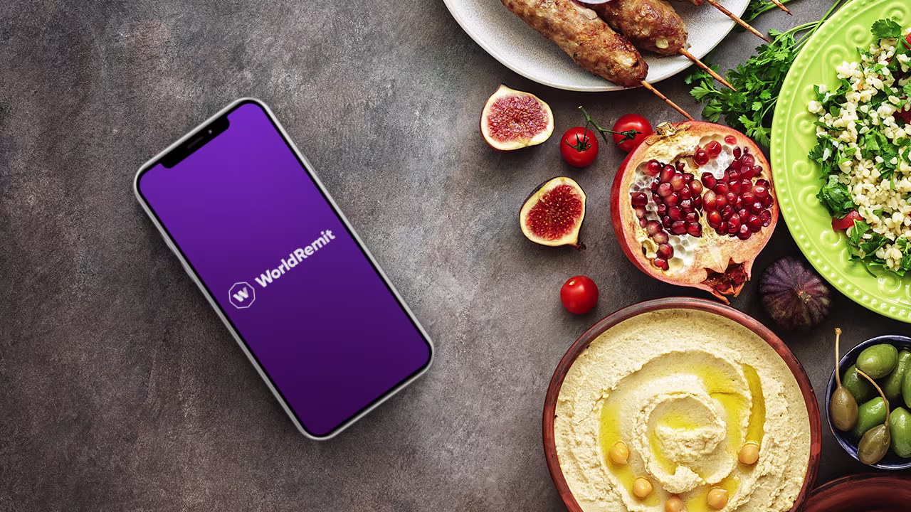 Picture of a phone showing WorldRemit on a table next to food
