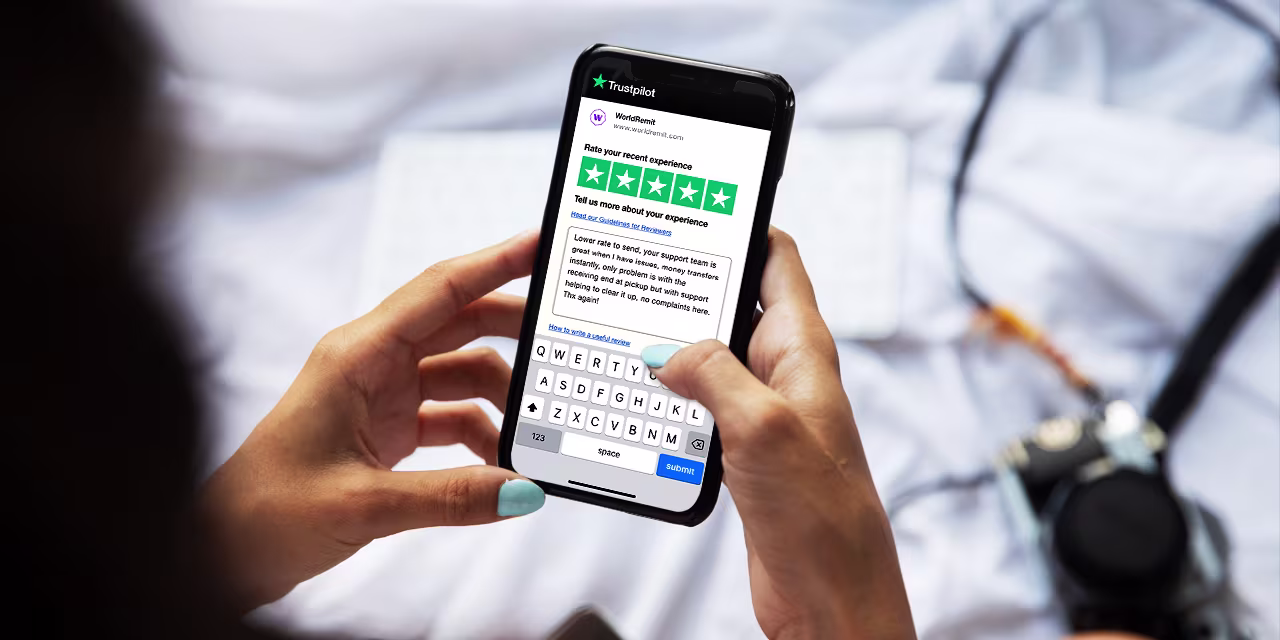 Writing a review A woman writing a 5 star review on her smartphone