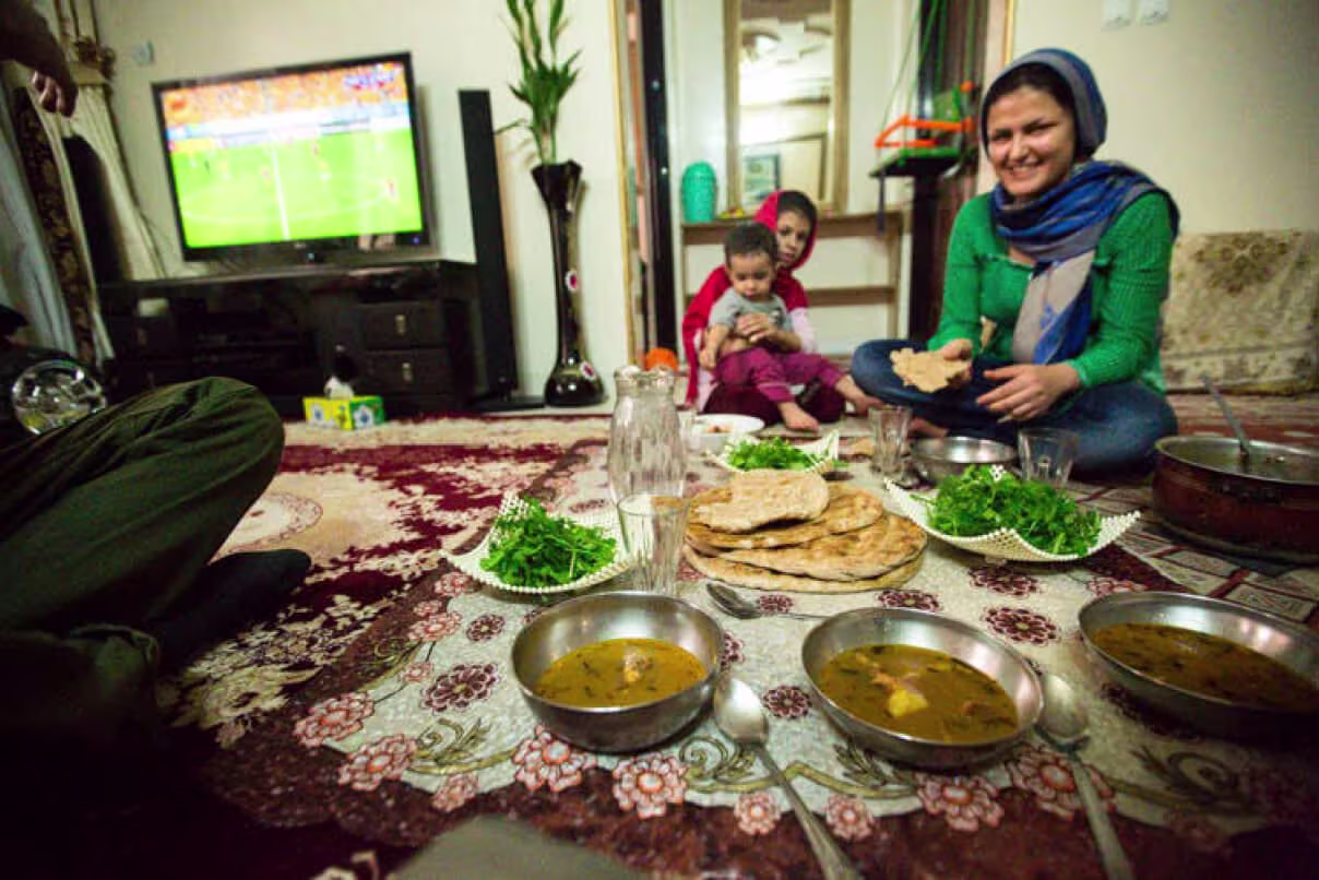 Sraza An image of a family sat eating food