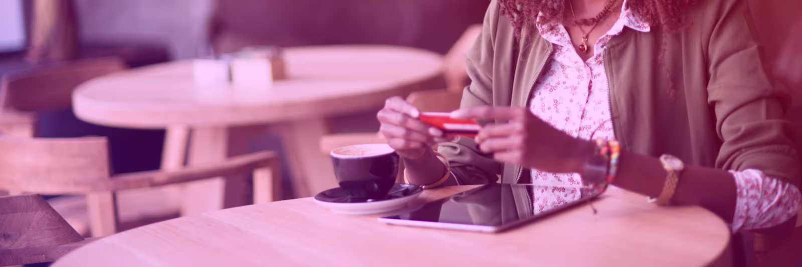 wire-transfer-header An image of someone sat at a table holding a debit card