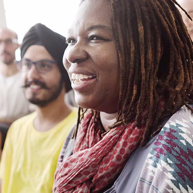 A group of mixed migrants sat in a room