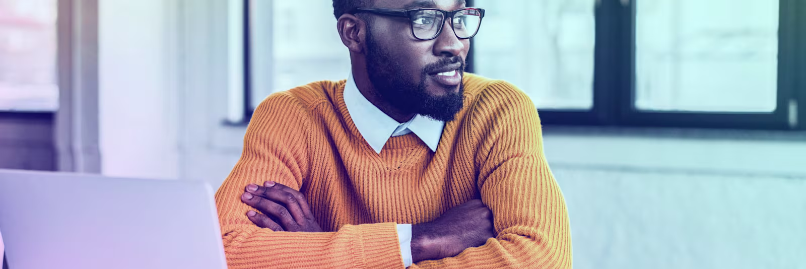 An image of a man looking to the side and smiling