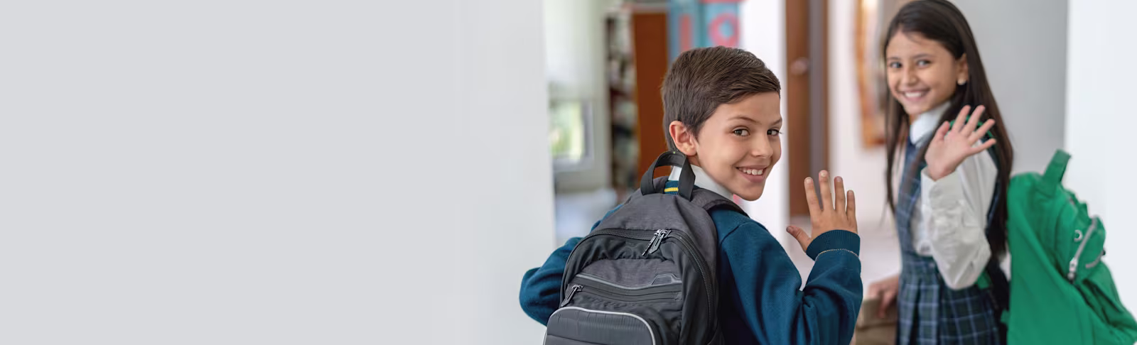 BTS Data Send PR A young boy and girl wearing backpacks, running whilst turning to look at the camera