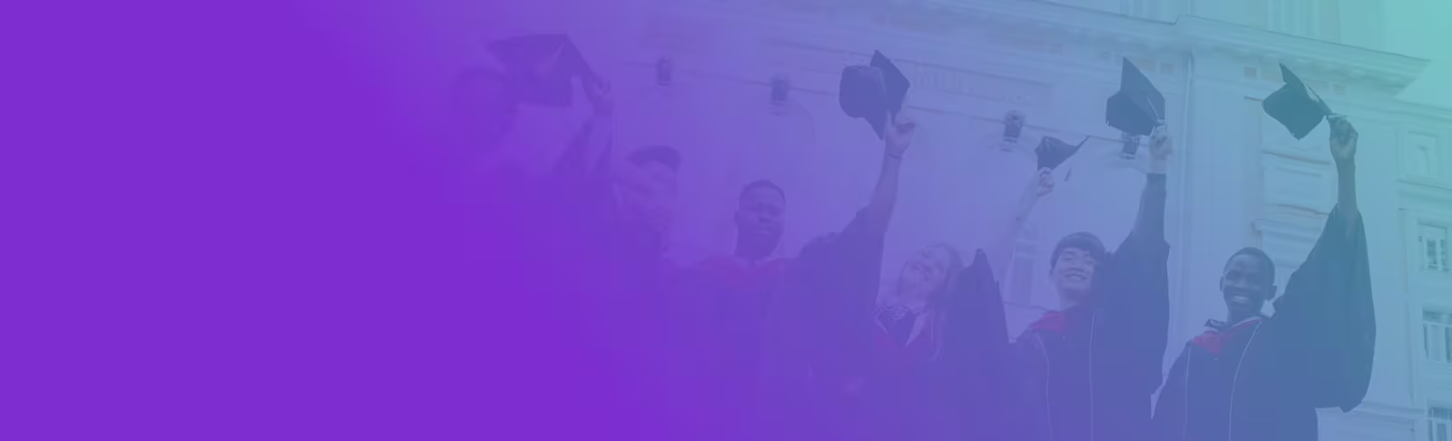 A group of graduates holding their graduation hats in the air