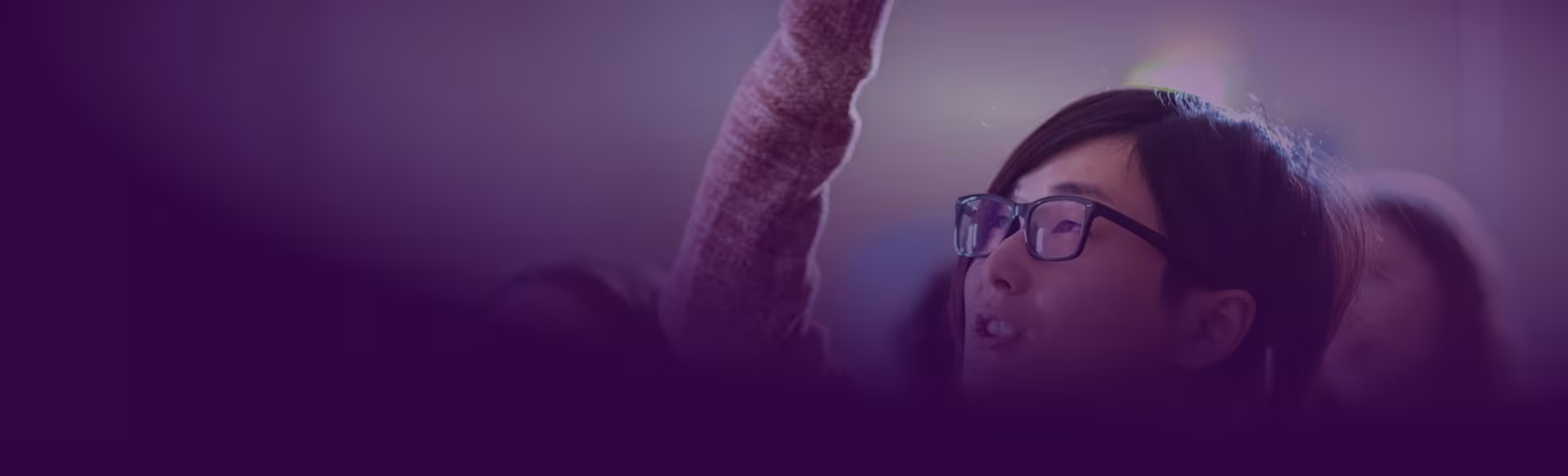 A purple banner, fading into an image of a girl wearing glasses