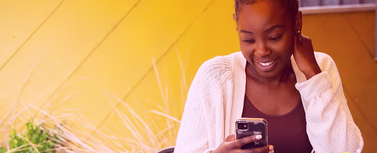 CRM Zimbabwe 1280x520px Women smiling on her phone