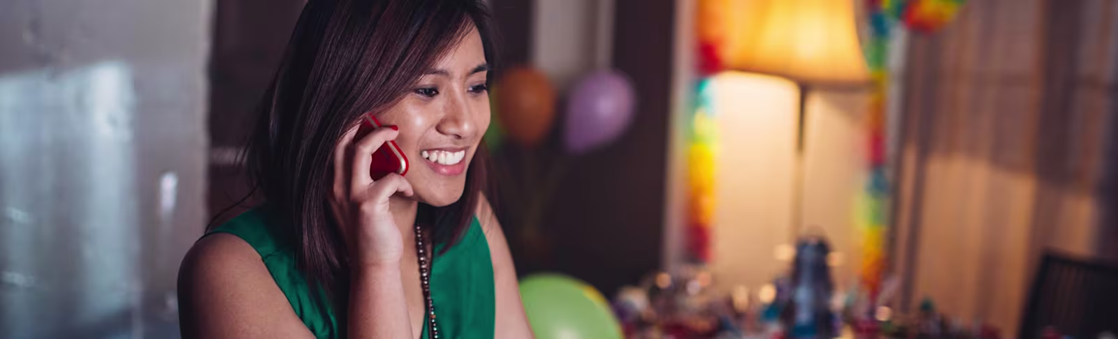 Banner Image - Asia Young Asian lady, smiling whilst talking on the phone.