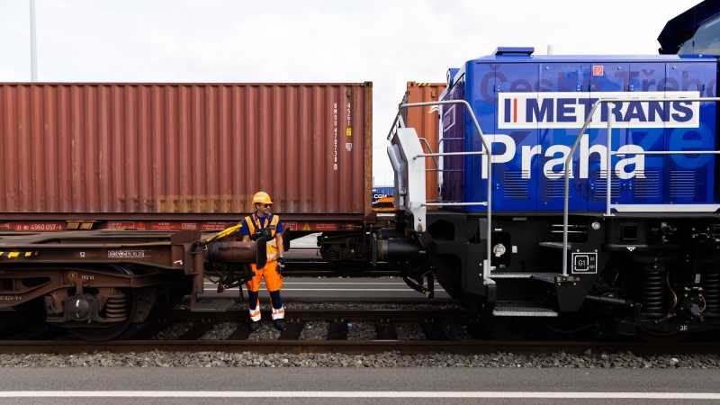 Eine Rangierlok wird an Leerwagons ohne Container angeschlossen.