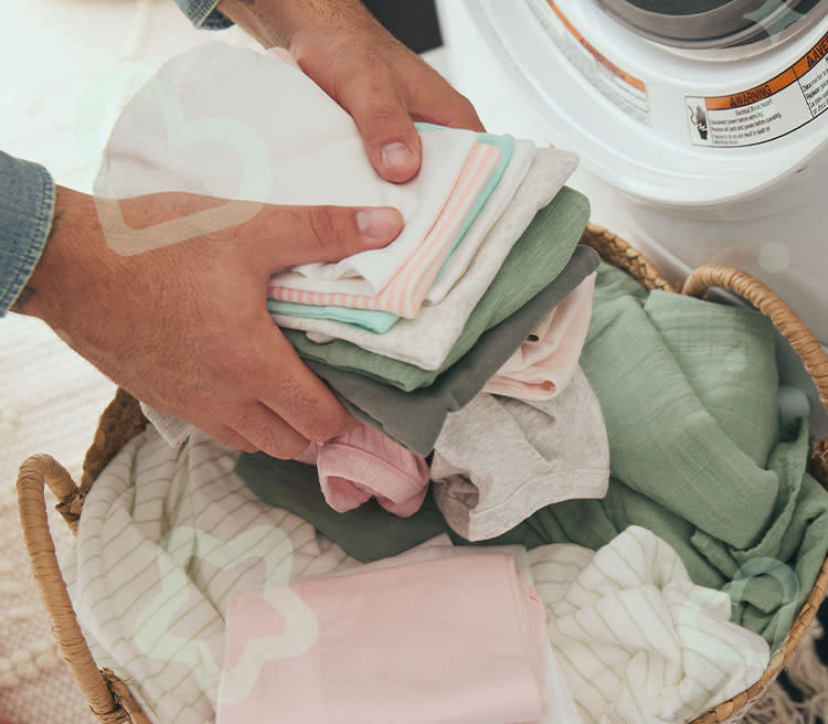 A stack of baby clothes being washed for the first time