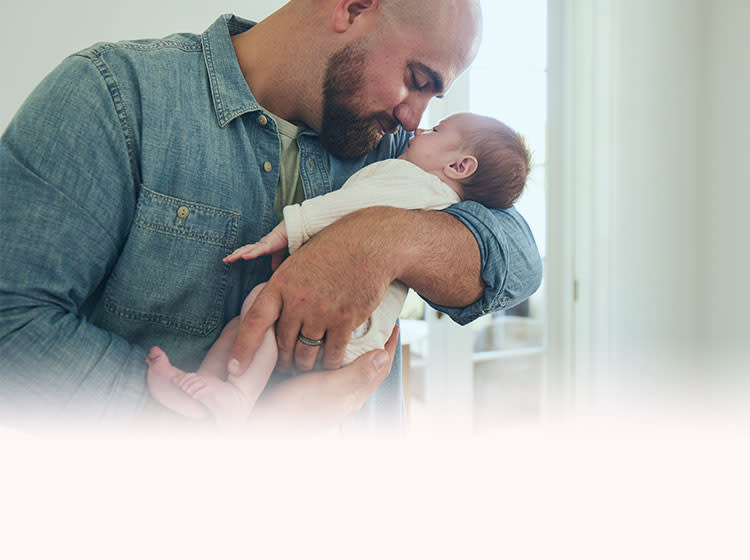 Man holding a baby in his arms