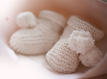 A pair of pink knitted gloves