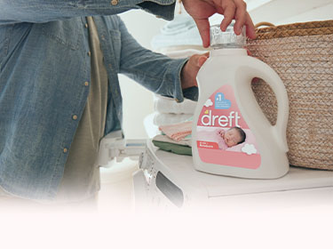 A man opening a Dreft bottle